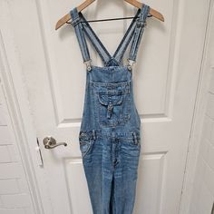 American Eagle Denim Tomgirl Overall New Without Tags, Only Tried On, Never Worn Size Medium Medium Shade Denim, Around ~27 Inch Inseam I'd Say More Straight/Tapered Leg Has Many Pockets, Including Front, Back, And Front Couple Pouches Wrinkle At The Bottom Where I Hung The Pants Up As My Closet Bar Was Too Low Light Wash Denim Jumpsuit With Straight Leg, Mid-rise Medium Wash Denim Jumpsuit, High Rise Washed Blue Denim Jumpsuit, Light Wash Denim Straight Leg Overalls, Light Wash Denim Overalls With Straight Leg, Washed Blue High Rise Denim Jumpsuit, Medium Wash Denim Jumpsuit, Medium Wash Mid-rise Denim Jumpsuit, Denim Jumpsuit With Frayed Hem