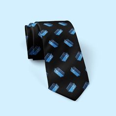 "Looking for the perfect gift for the Dr. Who fan in your life? Look no further than our dr who ties! This stylish necktie is made from high-quality materials and features a vibrant navy blue design that will make any fan of the Time Lord happy. It's also the perfect Father's Day gift, as it's sure to bring a smile to your loved one's face. Not only is this tie a great way to show your love for the Doctor, but it's also a fantastic addition to any man's wardrobe. So why not buy one today? You wo Navy Blue Design, Police Call, Time Lord, Comic Con Cosplay, Time Lords, Mens Neck Ties, Tie Accessories, Men's Wardrobe, Satin Material