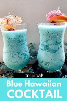 two glasses filled with blue hawaiian cocktail next to each other