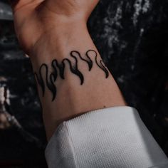 a woman's wrist with black ink on it