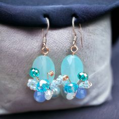 Beautiful handmade butterfly design earrings, aquamarine colour, made by our Fair Trade partners in Thailand. Earrings are approx. 4 cms long including sterling silver hooks by 1 cm wide. Please also visit my new shop, BALI COCONUT BY ROSA made in Fairtrade partnership with fine Balinese artisans and featuring all natural jewellery: https://www.etsy.com/uk/shop/BaliCoconutbyRosa Spend over $35 US Dollars with us and receive FREE postage for orders to the USA. Handmade Light Blue Aquamarine Jewelry, Aquamarine Dangle Earrings With Ear Wire, Aquamarine Drop Earrings With Ear Wire, Handmade Aquamarine Dangle Earrings, Handmade Blue Butterfly Earrings, Light Blue Crystal Drop Earrings For Gift, Turquoise Aquamarine Dangle Earrings, Light Blue Aquamarine Drop Earrings, Handmade Blue Aquamarine Earrings