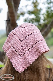 the back of a woman's head wearing a pink knitted hat