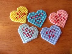 four small crocheted hearts with words on them