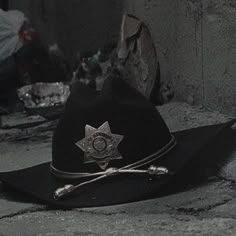 a black hat with a sheriff badge on it