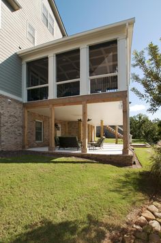 a large house with an attached deck and covered patio