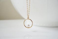 "Open circle necklace with floating diamond Necklace Dainty and Beautiful Perfect for layering or alone. A symbol of never ending love, our modern open circle necklace is elevated by a tiny floating diamond CZ, set inside. -Details Charm - 14kt gold filled, measures 15mm Gemstone - Pearl - 5mm Crystal Pearl Link Chain - 14kt Gold Filled Length - 14-30\" -How to Order Please select the length and chain choice from the drop down menu The standard length is normally 18\". For multiple necklace purc Circular Pearl Pendant Jewelry Gift, Minimalist Infinity Necklace For Anniversary Gift, Minimalist Infinity Necklace For Anniversary, Infinity Halo Jewelry Gift, Infinity Halo Jewelry As A Gift, Minimalist Circle Necklace For Anniversary, Elegant Birthstone Circle Necklaces, Elegant Circular Birthstone Necklaces, Elegant Birthstone Necklaces