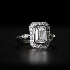 A beautiful emerald cut diamond engagement ring featuring a rare vintage GIA certified 1.26 carat emerald cut, G color, and VVS2 clarity. Surrounding the center diamond is a halo of diamond. This ring is platinum with a triple-wire shank. The emerald cut features beautiful vintage characteristics Fine Engagement Rings, Emerald Cut Diamond Engagement Ring, Emerald Cut Diamond Engagement, Victorian Ring, Antique Engagement Ring, Emerald Cut Moissanite, Beautiful Wedding Rings, Cushion Cut Engagement Ring, Fine Diamond Jewelry