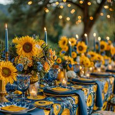 a table set with sunflowers and candles for a wedding or special event in blue and yellow