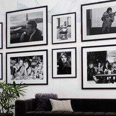 a living room with black and white pictures on the wall