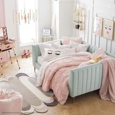 a bedroom with pink and white decor on the walls, bedding and rugs