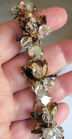 "Vintage, beaded DeLizza & Elster rhinestone bracelet with crystal beads and topaz (golden brown) and topaz AB rhinestones. This 5-link bracelet is  in excellent, clean condition. No missing, bad, dull or yellowing stones. No noticeable wear or damage to gold tone frame. Measures 7 1/4\" x about 1\"." Gold Jeweled Crystal Costume Bracelet, Costume Jewelry Crystal Jeweled Bracelets, Gold Crystal Party Bracelet With Stones, Gold Crystal Bracelet With Jewels, Gold Crystal Bracelet With Stones For Party, Gold Crystal Bracelet For Party, Jeweled Crystal Bracelet Costume Jewelry, Gold Crystal Bracelet Costume Jewelry, Gold Crystal Costume Bracelet