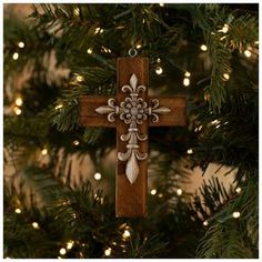 a wooden cross hanging from a christmas tree