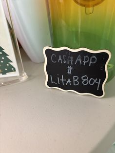 there is a sign that says cash app lita boy next to some vases