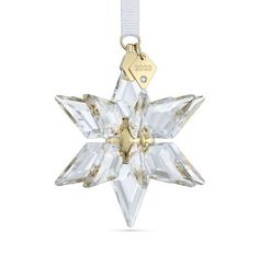 an ornament shaped like a snowflake with a tag hanging from it