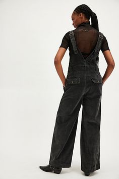 Cool in corduroy, these classic overalls are perfect for layering with your favorite intimates. **Fit:** Relaxed, wide-leg fit **Features:** Surplice wrap bodice, adjustable brace straps, pouch pockets, textured corduroy fabrication **Why We ❤ It:** Toughened up with moto boots or off-duty with court sneakers, this style has endless ways to wear. | Mara Cord Overalls by Free People in Black, Size: US 6 Cord Overalls, Outfit Styling, Black Overalls, Moto Boots, Off Duty, Pocket Pouch, Bodice, Layering, Overalls