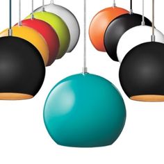 an assortment of different colored lamps hanging from strings