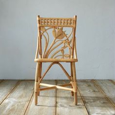 a wooden chair sitting on top of a wooden floor