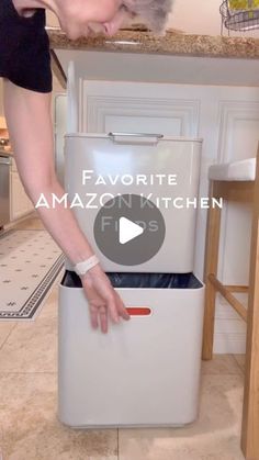 a woman is opening an oven in the kitchen