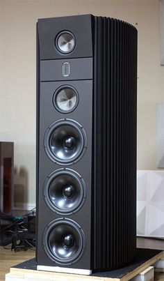 a large speaker sitting on top of a wooden platform