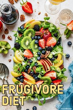 a plate with fruit, kiwis and strawberries on it is surrounded by other fruits