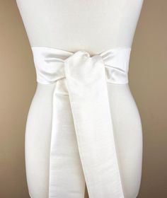 Wide Textured Off White Sash Belt  Off White Dupioni Sash  Light Ivory Dress Sash  Off White Fabric Belt  Wedding Dress Sash  Formal Sash  Add sophistication and crisp texture to your special occasion outfit with this Satin Swank® dupioni waist sash. Depending on your waist size and the length you choose (75 and 90 inch lengths available), you can wrap this sash around your waist once or twice. You decide whether to tie the sash in a bow or a simple knot with long-hanging tails. Tie in front, in back, or on the side. A double layer of crisp dupioni fabric in off white. Sash is the same front and back, seams are hidden within the fold lines, and ends are finished on the angle. Dupioni features a rustic weave with naturally occurring slubs and tiny thread loops running throughout the fabric Elegant Belted Sashes For Formal Occasions, Elegant Belted Sashes For Party, Elegant Fitted Bridal Belt For Bridesmaid, Elegant White Dresses With Sashes, Fitted Satin Sash For Evening, Elegant Bridal Belt With Satin Bow For Bridesmaid, Elegant Bridesmaid Belts With Sashes, Elegant Bridal Belt For Bridesmaid, Elegant Cream Sashes For Formal Occasions