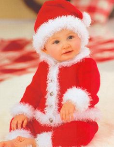 a baby wearing a santa suit and hat