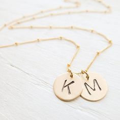 "Delicate and timeless, this sweet necklace features goldfill discs that are stamped with a 1/4\" uppercase arial font initial of your choice. The disc(s) stand alone on 14K goldfill satellite chain. . { m e a s u r e m e n t s } . 1/2\" discs 16 or 18 inches . { o p t i o n s } . Please leave personalization preference in the notes to camileedesigns field at checkout If you would like to add birthstone charms you can do so here: https://www.etsy.com/listing/152899880/add-a-birthstone-gemstone-o Gold Initial Pendant Necklace For Best Friend, Personalized 14k Gold Filled Initial Necklace, Minimalist Gold Name Necklace For Best Friend Gift, Hand Stamped Initial Pendant Necklace, Minimalist Gold Name Necklace For Best Friend, Personalized Gold Dainty Coin Necklace, Dainty Personalized Gold Coin Necklace, Personalized Gold Initial Necklace For Best Friend, Hand Stamped Gold Necklace For Best Friend