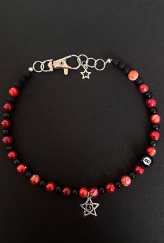 handmade beaded necklace by DJ. Made with red fire agate beads, obsidian and lava beads. Centered with a star swirl charm. Good for protection and looking punk. Diy Bracelets And Necklaces, Emo Beaded Jewelry, Red Bead Necklace, Handmade Edgy Necklace For Halloween, Edgy Handmade Necklace For Halloween, Red Emo Necklace For Gift, Emo Beaded Necklace, Beaded Necklace Ideas, Red Beads Necklace