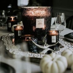 a table with candles and plates on it