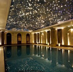 an indoor swimming pool with stars on the ceiling