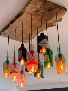 a chandelier made out of bottles hanging from the ceiling