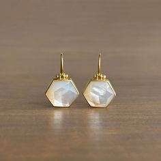 Lustrous mother of pearl from Mexico glistens from within their expertly crafted bezels in this divine pair. 

18k yellow gold 
Mother of Pearl, 8.28ctw, 14mm x 12mm (9/16" x 1/2")
Earrings hang 7/8" from the ear 
Each earring weighs 1.9g Luxury Octagon Gemstone Earrings, Fine Jewelry Gold Octagon Earrings, Gold Octagon Earrings Fine Jewelry, Octagon Gold Earrings In Fine Jewelry Style, Gold Octagonal Earrings In Fine Jewelry Style, Luxury Gold Faceted Earrings, Yellow Gold Mother Of Pearl Round Earrings, Yellow Gold Mother Of Pearl Earrings For Gift, Mother Of Pearl Earrings With High Luster For Gifts