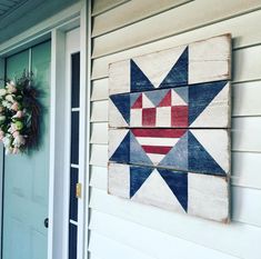 an american flag star is hanging on the side of a house