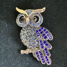 This Exquisite Brooch Features A Stunning Owl Design With Sparkling Blue Rhinestones And A Cluster Setting Style. The Antiqued Copper Tone Metal Make It A Unique And Durable Piece Of Jewelry. Perfect For Any Occasion, Whether It's A Graduation, Wedding, Anniversary, Or Just A Special Gift For Mother's Day, Father's Day, Christmas, Or Halloween. The Brooch Is Also A Great Addition To Any Collection, With Its Intricate Design And Modern Era. Rose Gold/Copper Tone Metal. Pictures Cannot Do It Justi Costume Jewelry Blue Brooches With Rhinestones, Elegant Multi-stone Brooches For Gifts, Gold Multi-stone Brooches For Formal Occasions, Blue Crystal Jewelry Brooch, Metal Pictures, Blue Crystal Brooches For Gifts, Blue Crystal Brooch Jewelry, Blue Crystal Jewelry With Brooch Detail, Blue Crystal Brooches With Rhinestones