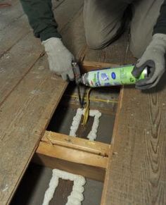 a man is working on some wood with glue