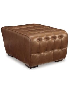 a brown leather ottoman sitting on top of a white floor