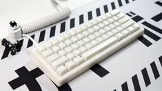 a white computer keyboard sitting on top of a table