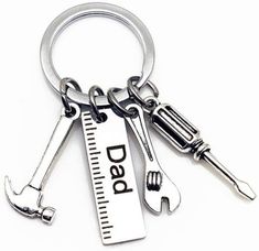 three wrench and ruler key chains with the words dead on them