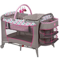 a baby crib with pink trim and polka dots