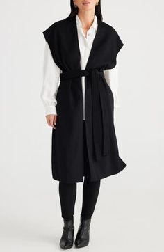 A cape-inspired longline silhouette makes this belted vest a modern layering standout. 43" length (size Small/Medium) Open front Cap sleeves Removable tie belt Side slits 50% wool, 50% polyester Dry clean or hand wash, dry flat Imported Versatile Long Outerwear For Work, Black Wrap Outerwear For Work, Elegant Belted Wrap Outerwear, Elegant Wrap-style Belted Outerwear, Modern Sleeveless Outerwear For Work, Elegant Black Wrap Outerwear, Chic Wrap Outerwear For Work, Versatile Wrap Outerwear For Work, Long Vest Outfits For Women