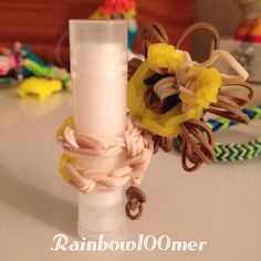 a vase with some flowers in it sitting on a table next to bracelets and other items