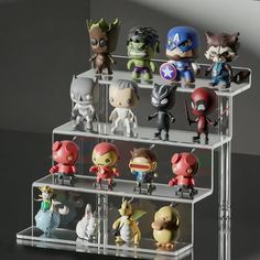 the avengers action figures are on display in a clear case with acrylic stand