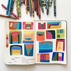 an open notebook with crayons and markers on it