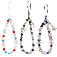 three necklaces with charms hanging from them