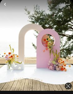 flowers are placed in front of the letters that spell out love on a white table