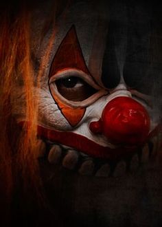 a scary clown's face is shown in this artistic photo with red hair and makeup