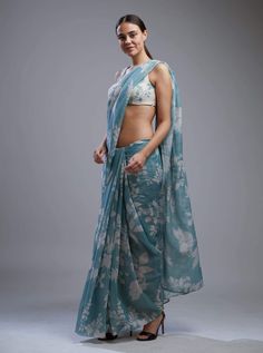 Editor's Note Featuring a blue and white floral saree with blouse. Color: Blue; White Fabric: Chanderi Silk Care: Dry Clean Only About the Designer KoAi means "Love Child" Non-fussy clothes for everyday wear. These pieces can be worn at any time of the day.i.e for work, brunch, evening wear, by the pool. Basically everywhere. Blue Floral Print Dupatta For Navratri, Floral Print Saree For Summer, Summer Floral Print Saree, Blue Blouse With Sheer Dupatta, Fitted Blue Pre-draped Saree With Floral Print, Blue Floral Pre-draped Saree For Festive Occasions, Blue Floral Print Saree For Diwali, Diwali Blue Floral Print Saree, Unstitched Summer Floral Print Blouse Piece