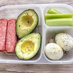 an avocado, egg, sausage and celery in a plastic container