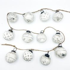 Flat lay photography of a Christmas garland. Made up of white washed glass baubles on jute string. Christmas Bauble Garland, Bauble Garland, White Christmas Decorations, Glass Christmas Baubles, White Garland