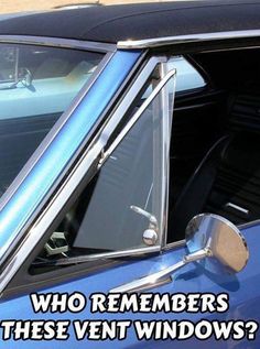 an old blue car with its door open and the side window partially closed to show it's interior